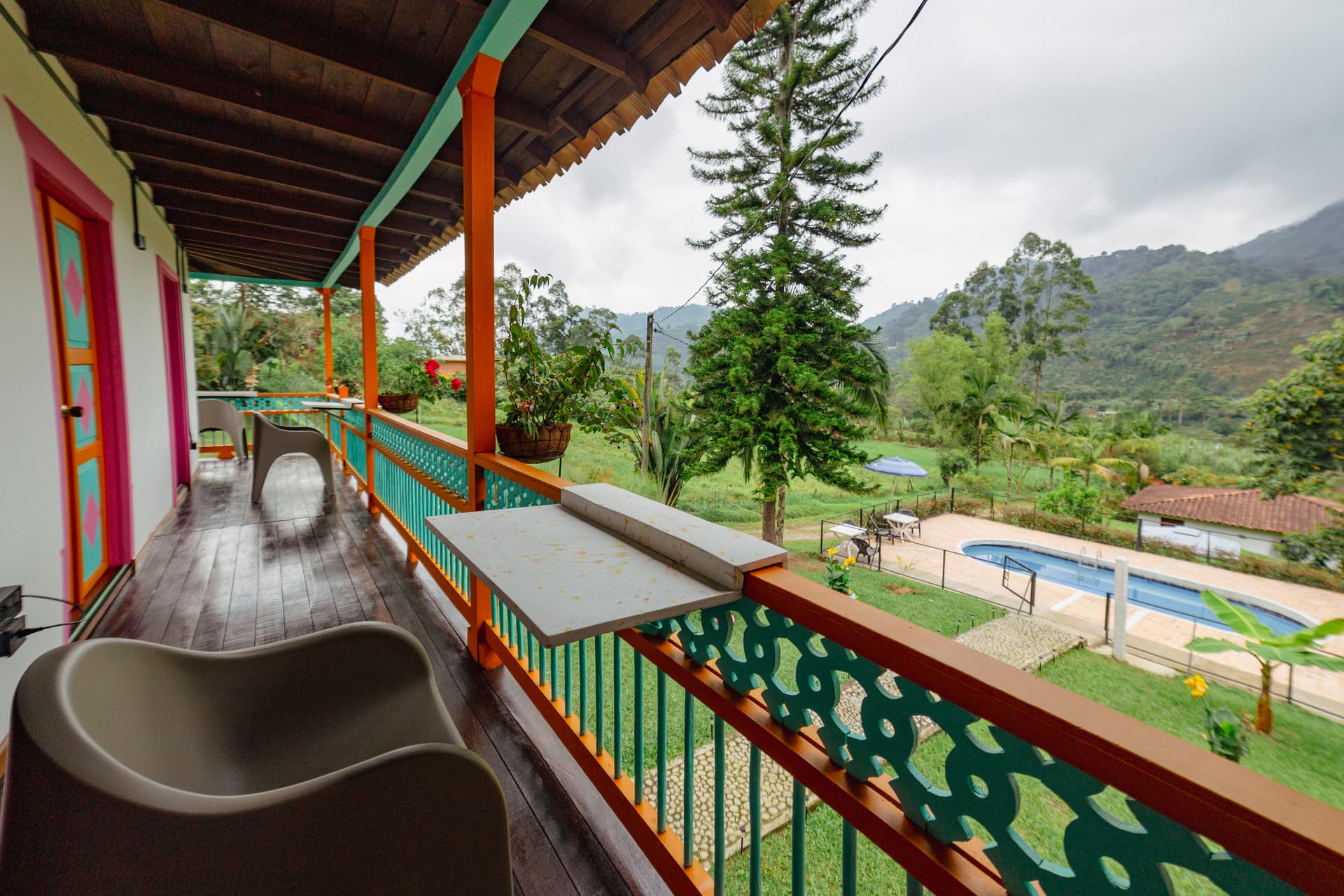 Rail-mounted desks along the upper balcony overlooking the pool and mountains